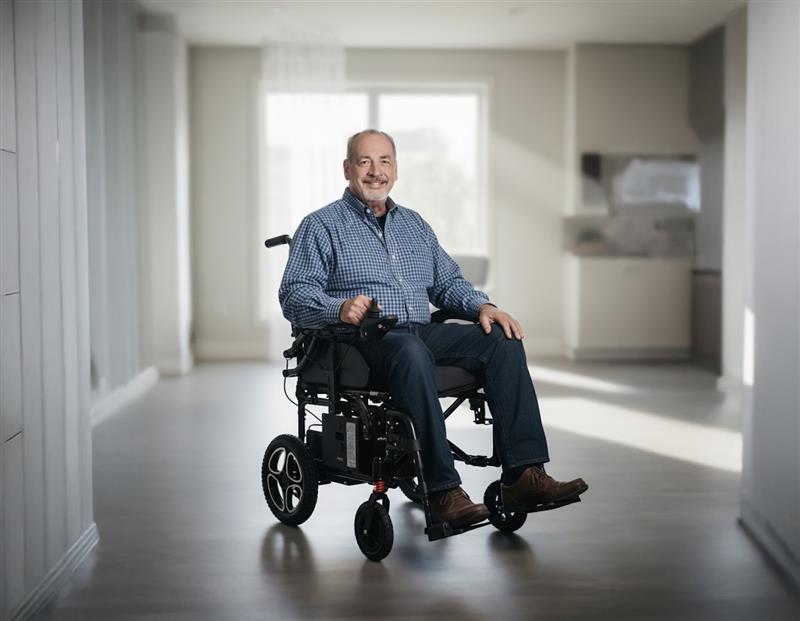 Man sitting in a Journey Air power wheelchair indoors