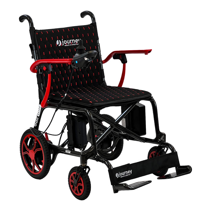The Journey Air Elite Lightweight Folding Power Chair features a black and red design, padded seat, right-arm joystick control, large rear and small front wheels, footrest, and visible Journey branding on the seat and footrest. It is easy to fold and lightweight.