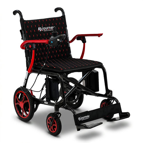 The Journey Air Elite Lightweight Folding Power Chair is a black and red portable electric wheelchair featuring armrests, footrests, joystick control, and foldable design with red accents. Journey branding appears on the footrest and backrest.