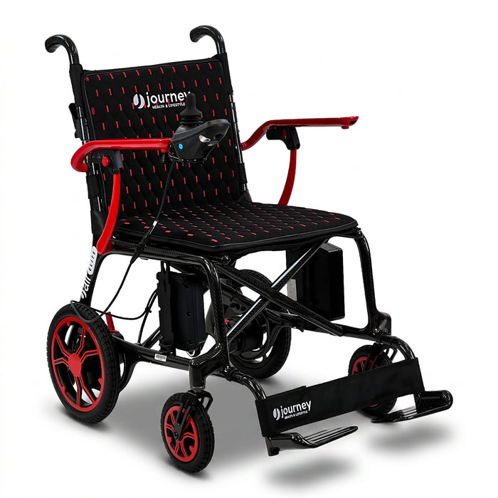 The Journey Certified Pre-Owned Air Elite Lightweight Power Chair in red and black features joystick control, a padded seat, footrests, and large rear wheels—ideal as a travel mobility chair for easy transportation.