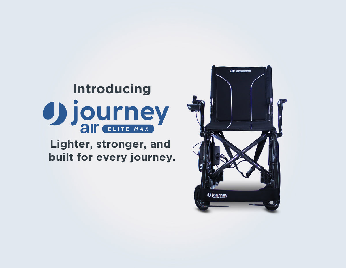 Promotional hero image for the Journey Air Elite Max power wheelchair. On the left, large text reads 'Introducing Journey Air Elite Max' above the slogan 'Lighter, stronger, and built for every journey.' On the right, a front-facing view of the sleek, black carbon-fiber electric wheelchair is displayed against a clean, light-grey gradient background. The wheelchair features a wide memory-foam seat, a tall backrest with white accent lines, and a joystick controller on the armrest.