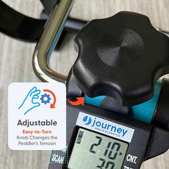 Close-up of the Journey Exercise Peddler’s easy-to-turn tension knob above a digital display, with an orange arrow and hand graphic. Text: Adjustable knob lets you change the Journey Portable Pedal Exerciser’s resistance.