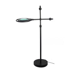 The Journey™ 5X Floor Magnifying Glass with LED Light is a black standing lamp with an adjustable arm, circular lens, and round base—ideal for hands-free reading or detailed work.