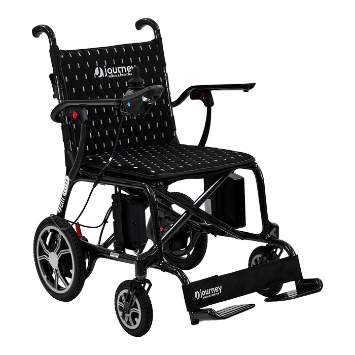 The Journey Air Elite Lightweight Folding Power Chair is black, lightweight, foldable, with a joystick armrest control, padded seat bearing the Journey logo, large rear wheels, and convenient footrests.