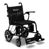 The Journey Air Elite Lightweight Folding Power Chair is black, lightweight, foldable, and features a joystick control, comfy seat, sturdy frame, large wheels, labeled Journey footrest, supportive armrests, and is ideal for mobility assistance and easy transport.