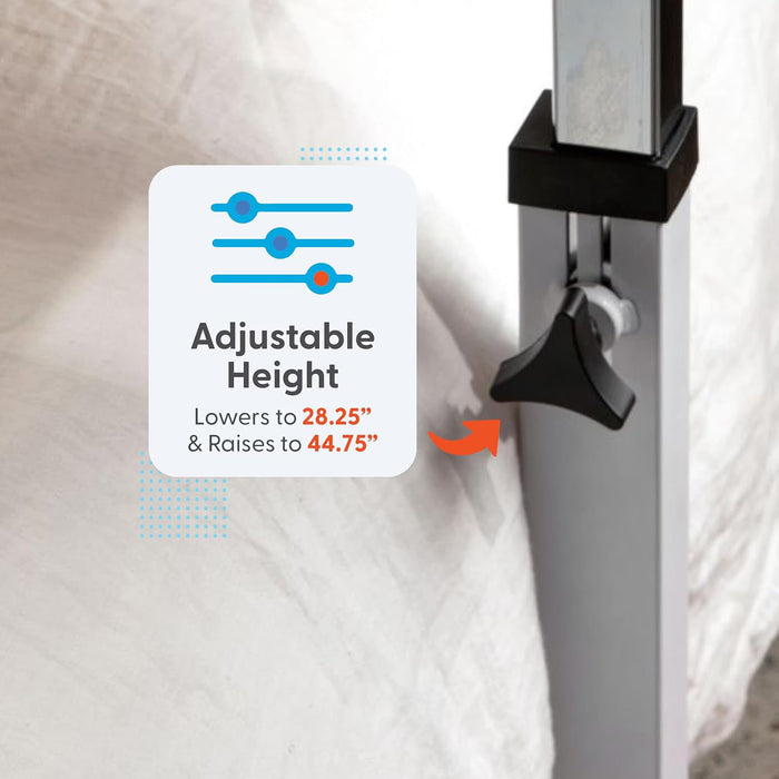 Close-up of the metal adjustable-height mechanism on a Journey Overbed Table – Adjustable & Portable Design leg. A graphic highlights Adjustable Height, with text: Lowers to 28.25″ & Raises to 44.75″. This portable table features an easy-clean tabletop, while a bed and white blanket are seen in the background.