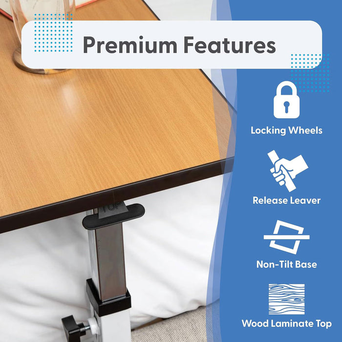 The Journey Overbed Table – Adjustable & Portable Design is shown beside a bed, featuring a wooden tabletop with a sturdy metal adjustable base. Premium features—locking wheels, easy-release lever, stable non-tilt base, and an easy-clean surface—are highlighted with icons on a blue background. This makes it the perfect rolling bedside table solution.
