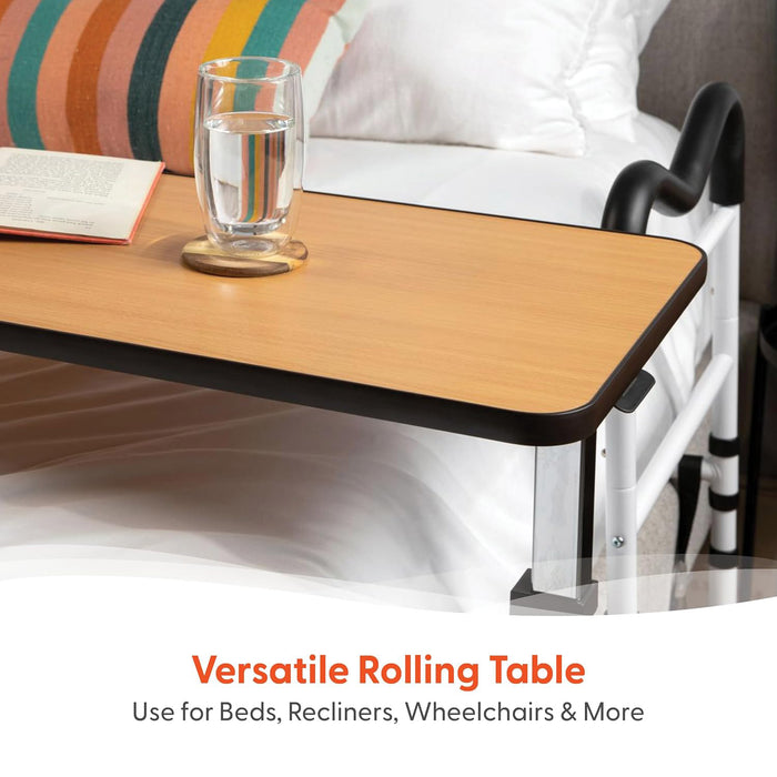 The Journey Adjustable Height Overbed Table with swivel casters is shown over a bed, holding a glass of water and an open book. Text: Versatile Rolling Table – Perfect for Beds, Recliners, Wheelchairs & More.