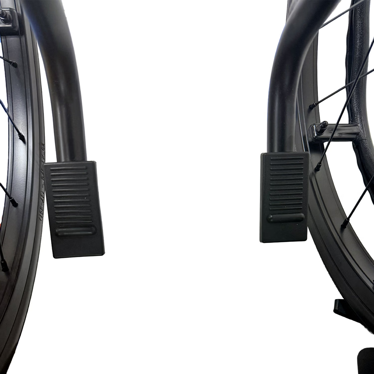Close-up view of two black footrests and wheels of the No Anti Tippers - Journey So Lite C2 Ultra Lightweight Folding Wheelchair with Blue Trim against a white background.