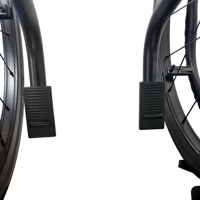 Close-up view of two black footrests and wheels of the No Anti Tippers - Journey So Lite C2 Ultra Lightweight Folding Wheelchair with Blue Trim against a white background.