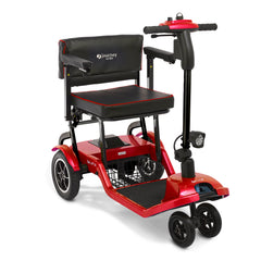 The Journey So Lite Folding Power Scooter is a red and black lightweight mobility scooter with a padded seat, backrest, handlebars, foot platform, and three front wheels. Designed for easy transport and accessibility.