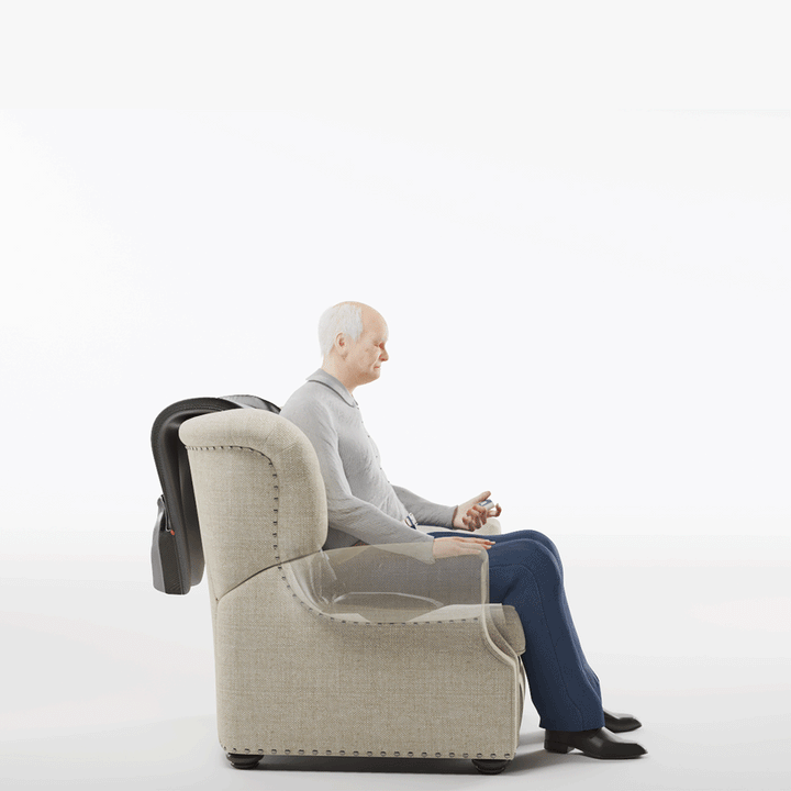 A senior man sits upright in the beige SitNStand Lift Assist Classic for Home, holding a remote. The chairs side is transparent, showing its internal mechanism behind him. The background is plain white.