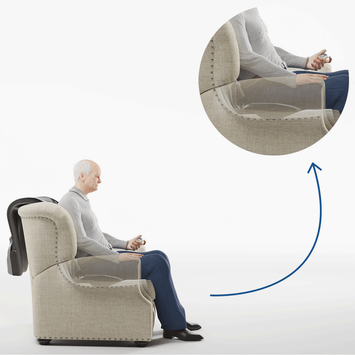 An elderly man sits upright in a beige armchair using the SitNStand Lift Assist Classic for Home, holding its remote. A magnified inset shows his relaxed hand on the chairs armrest, highlighted by a blue arrow.