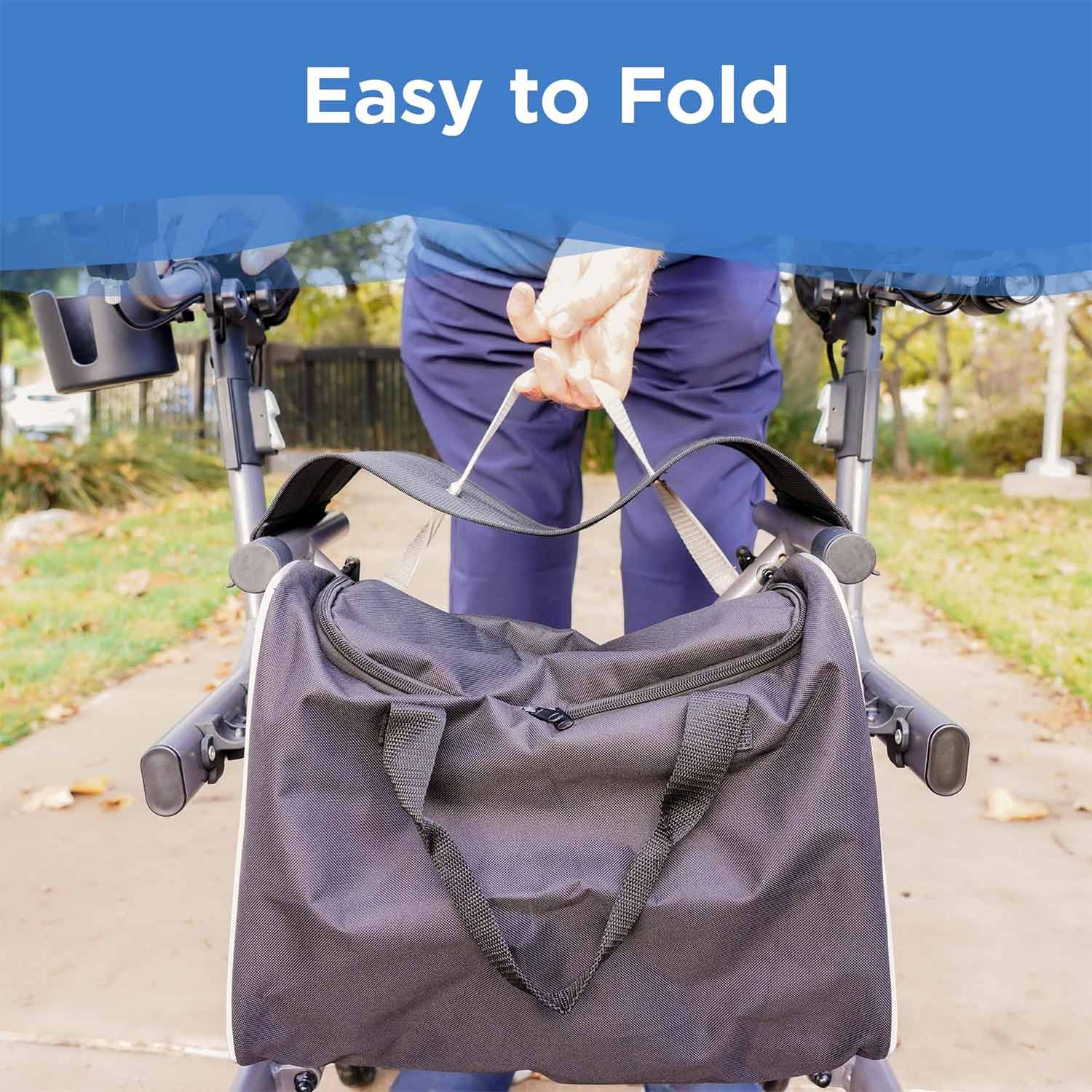 A person folds a Journey Certified Pre-Owned UpWalker Lite walker by lifting a strap on its black storage bag. The image displays the text Easy to Fold at the top, with the walker outdoors on a paved path.
