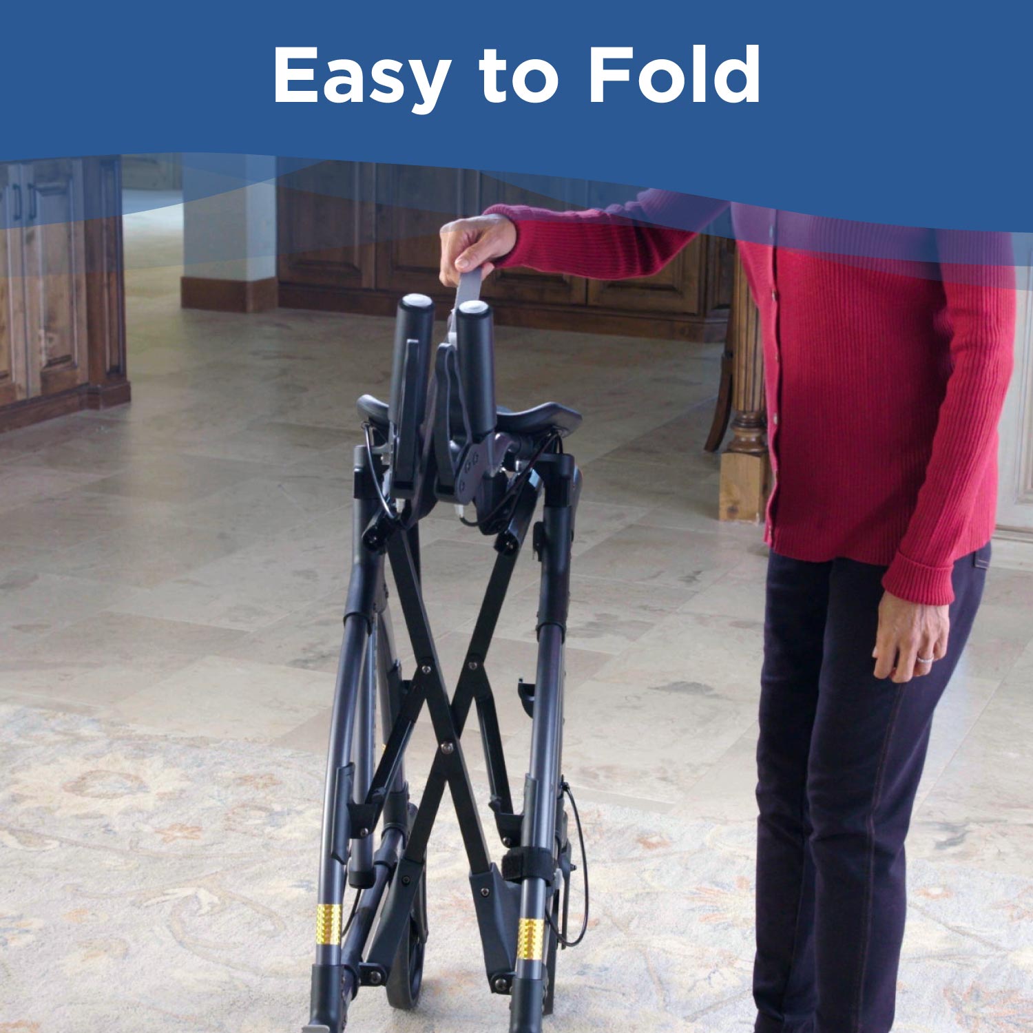 A person in a red sweater folds an UPWalker Original black mobility walker at home. The phrase Easy to Fold appears at the top of the image.