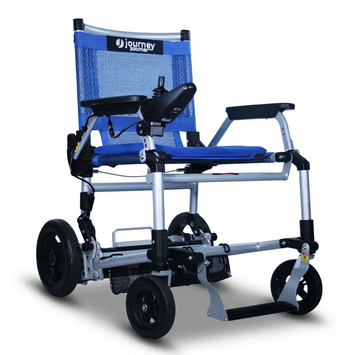 The Journey Zoomer Lightweight Folding Power Chair features a blue and silver frame, black armrests, joystick controls, mesh backrest, and large rear wheels for easy mobility.