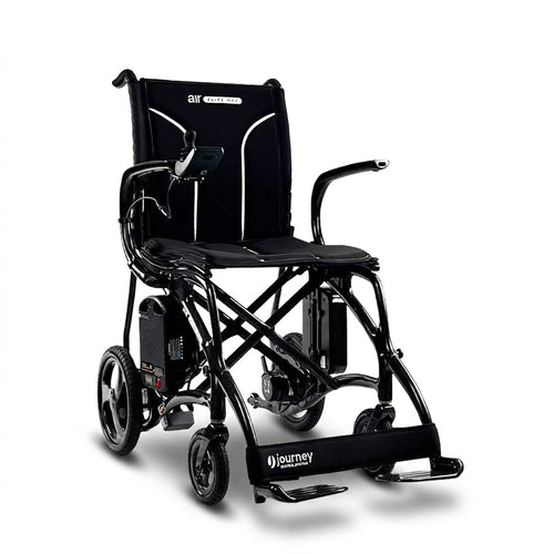 The Journey Air Elite Max Ultra-Lightweight Portable Power Chair is a black electric wheelchair with a padded seat and backrest, armrests, right-arm joystick controller, footrests, and large rear wheels.