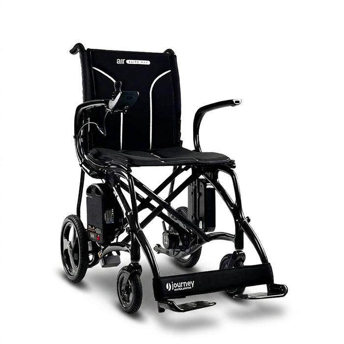 The Journey Air Elite Max Ultra-Lightweight Portable Power Chair is a black electric wheelchair with a padded seat and backrest, armrests, right-arm joystick controller, footrests, and large rear wheels.