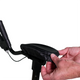 A person adjusts a black padded seat cover onto a bicycle seat, holding and smoothing it over, similar to fitting the Journey UPWalker Lite Universal Arm Rest Pad – Replacement. The background is white.