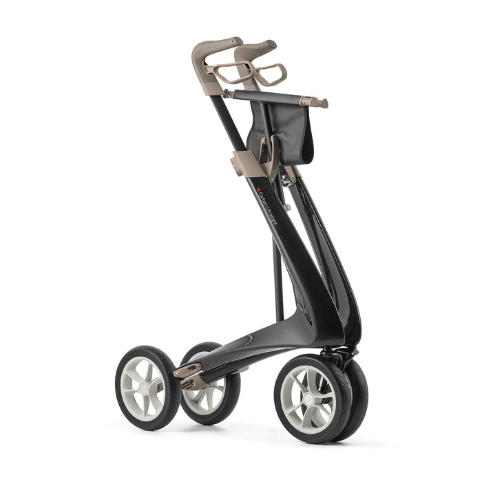 The byACRE Carbon Ultralight Rollator, shown standing upright on a white background, features a modern four-wheeled design with a sleek black frame, beige handle, and white-spoked wheels.