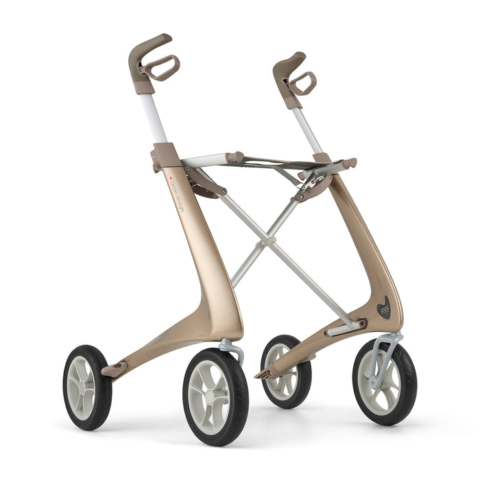 The byACRE Carbon Ultralight Rollator is a modern, minimalist rollator with four wheels, a metallic gold and white frame, ergonomic handles, and no seat—designed for enhanced mobility and support.