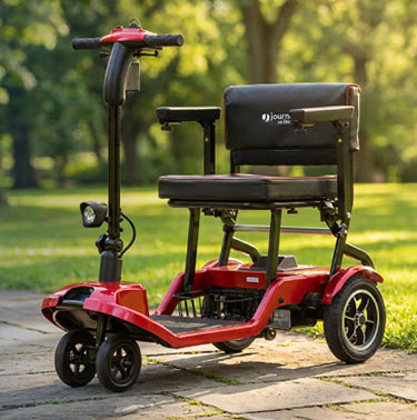 A Red Journey So LIte Scooter parked on a path in a park