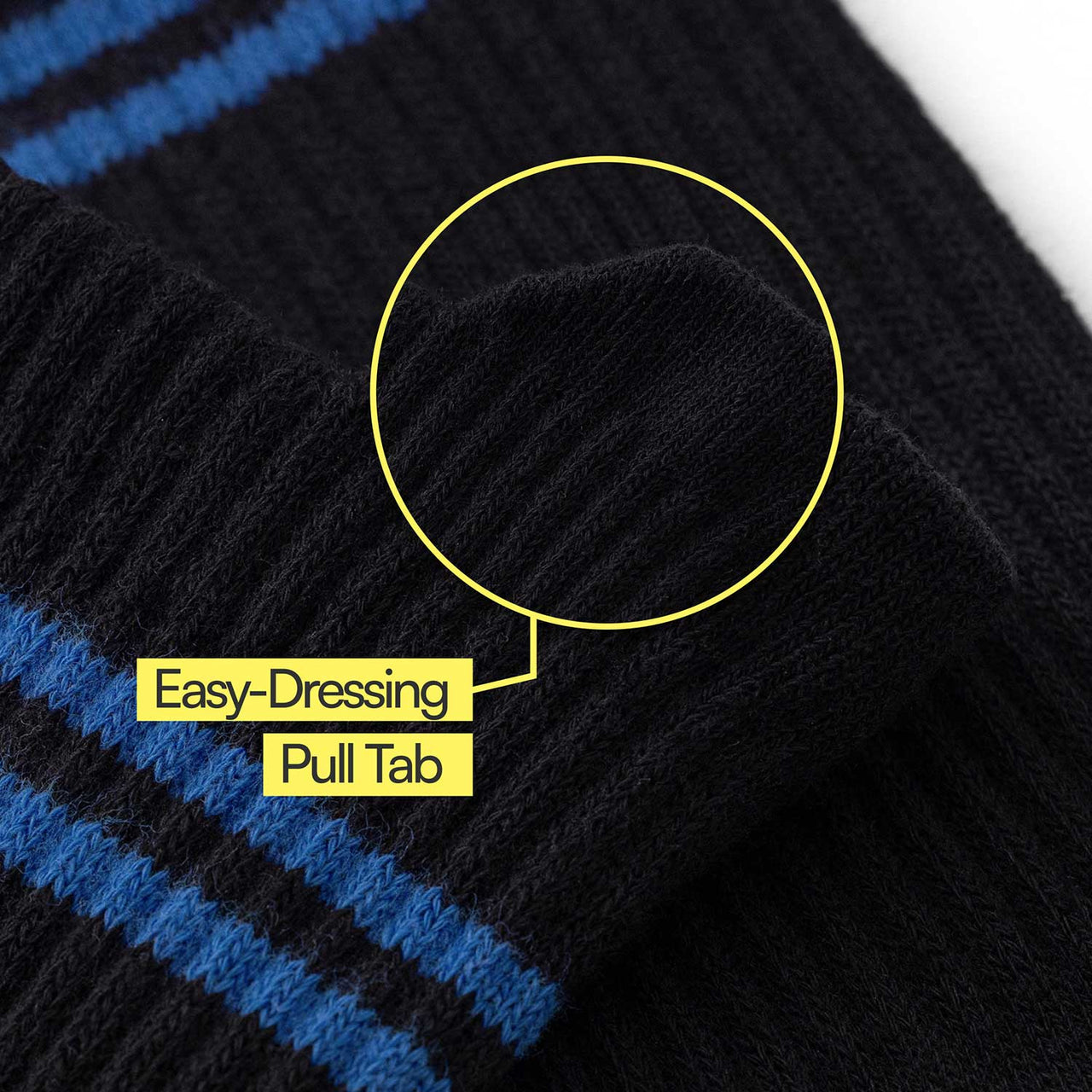 Close-up of a black Big-Grip No-Slip Compression Sock, with blue stripes and ribbed texture. A yellow circle highlights the easy-dressing pull tab and labeled text points to silicone grips for extra security.