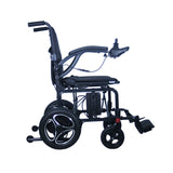 Side view of the Journey Air 2026 portable folding electric power chair showing its compact frame, armrests, footrest, and lightweight folding design for travel and storage.