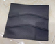 A black, square Journey Air Elite - Replacement Seat Cushion with two horizontal stitched lines sits on a shiny, light-colored tiled floor.