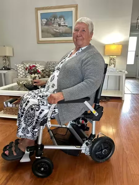 Journey Health customer seated in compact power wheelchair at home
