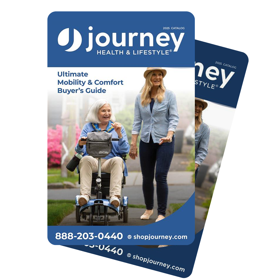 A printed brochure or catalog cover for Journey Health & Lifestyle, featuring a photo of an older woman in a wheelchair and another woman walking beside her. The cover has a blue header and footer with the text '2026 Catalog' and contact information, shown on a white background with a second copy partially visible behind it.