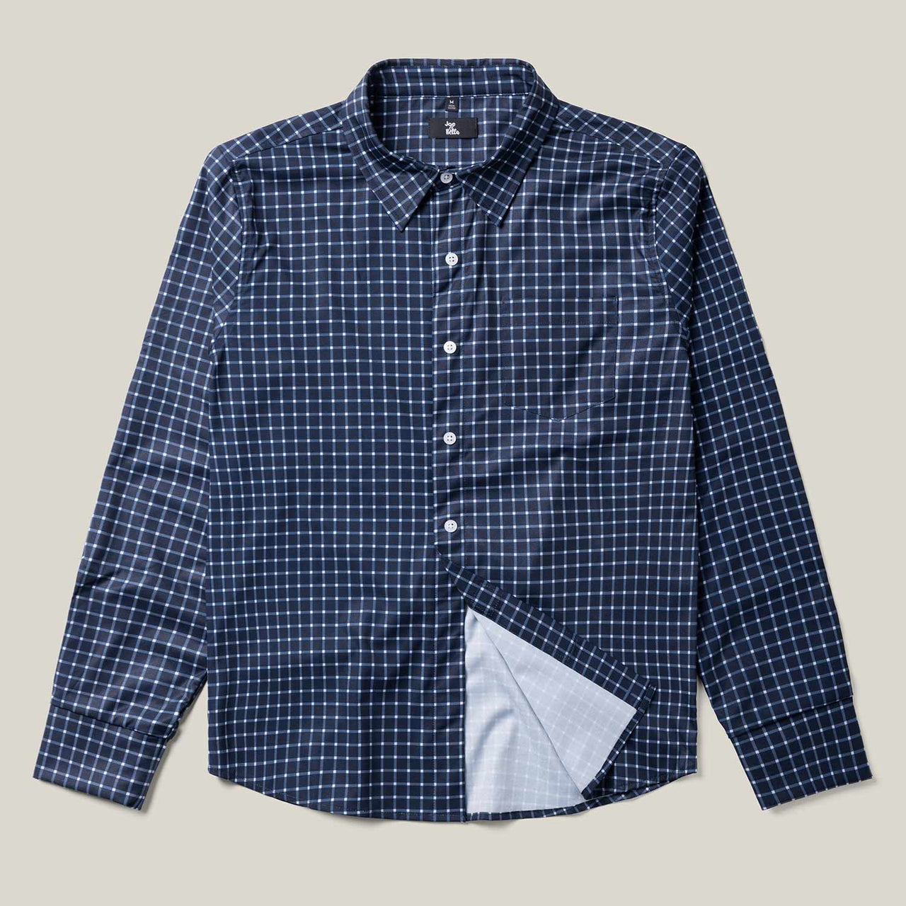 The Relaxed-Fit Magnetic Button-Down Shirt for Men, in blue and white checkered fabric with long sleeves, is laid flat with one corner flipped to highlight its lighter inner lining and adaptive magnetic fasteners for comfort and convenience.