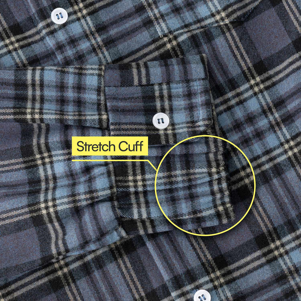 Close-up of a blue and black plaid Flannel Magnetic Button-Down Shirt for Men with white buttons. A yellow label highlights the stretch cuff for comfort, making it an excellent option for adaptive clothing.