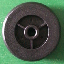 The So Lite® Scooter Anti-tip Wheels are black plastic replacement wheels with a central hole and three spokes, designed specifically for the So Lite® Scooter. Pictured on a green surface, they provide added stability and safety.