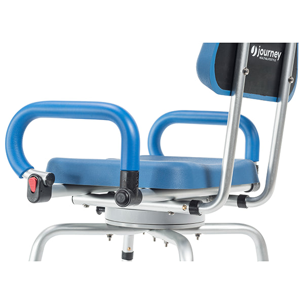 A close-up of the Journey SoftSecure Rotating Shower Chair with Microban Protection, featuring blue and silver design, armrests, padded backrest for comfort, and a red safety latch on one armrest for added security.