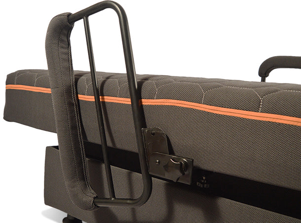 A close-up of a black metal safety rail attached to the UPbed® Standard 4-in-1 Motorized Lift Bed’s gray memory foam mattress with an orange stripe. The padded rail helps prevent users from rolling out of bed.