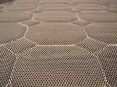 Close-up of the UPbed® Standard 4-in-1 Motorized Lift Bed’s grayish-brown fabric, showing a hexagonal stitched pattern with raised, padded sections and visible seams—evoking plush comfort similar to memory foam.