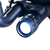 Close-up of the Journey UPWalker Flashlight – Easy Install, a hands-free light mounted on a black bicycle handlebar, illuminating the path ahead for improved safety and visibility.