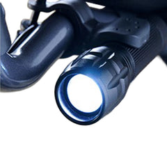 Close-up of the Journey UPWalker Flashlight – Easy Install, a hands-free light mounted on a black bicycle handlebar, illuminating the path ahead for improved safety and visibility.
