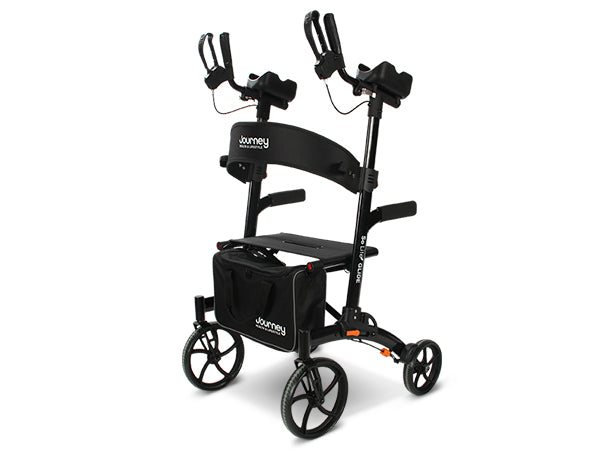An Open Box So Lite® Glide Backsaver Rollator Walker in black features four wheels, ergonomic forearm supports, hand brakes, a padded seat, and a storage bag. The certified pre-owned Journey branding is visible on the walker and bag.