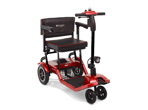 Discover the compact red So Lite® Lightweight Folding Scooter: four wheels, padded black seat and backrest, handlebars with controls, front-facing light, and a storage basket. Available certified pre-owned.