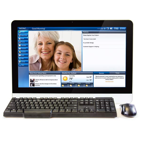 The WOW Computer displays a video call between an older woman and a young girl, plus news, weather, and notices. The easy-to-use monitor is paired with a keyboard and mouse in front.