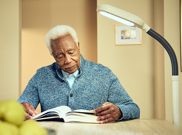 Man reads with Balanced Spectrum Lamp